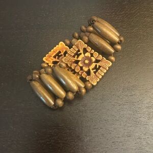 Stretchy beaded, carved wooden bracelet.